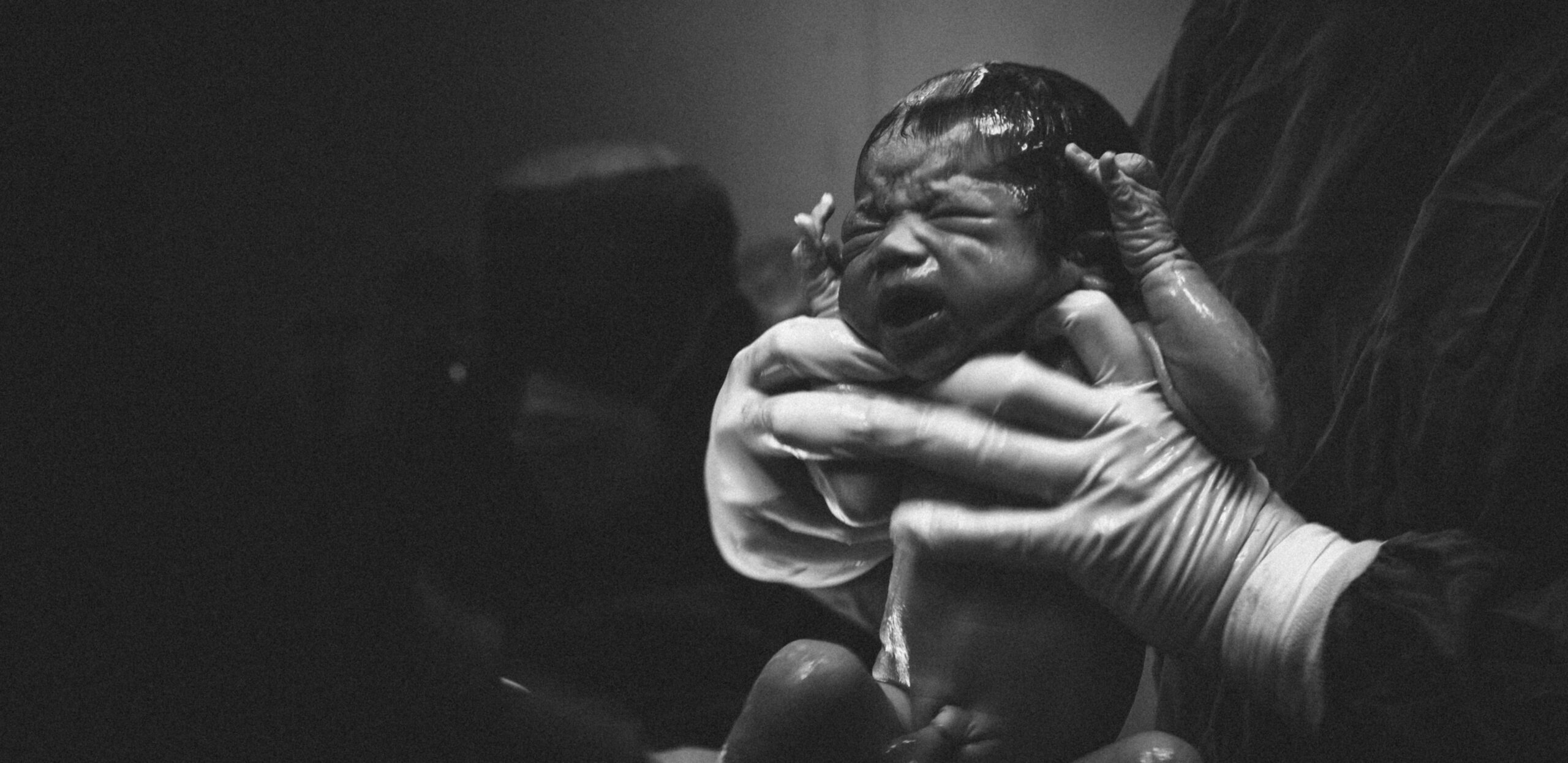 Tender moment of a parent with a newborn
